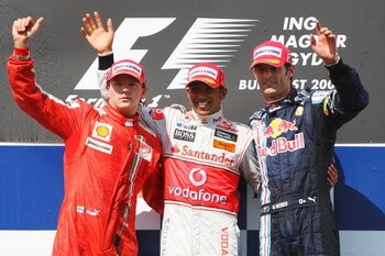 BUDAPEST, HUNGARY - JULY 26:  First placed Lewis Hamilton (C) of Great Britain and McLaren Mercedes celebrates on the podium with second placed Kimi Raikkonen (L) of Finland and Ferrari and third placed Mark Webber of Australia and Red Bull Racing followi