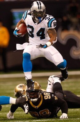 NEW ORLEANS - DECEMBER 28:  DeAngelo Williams #34 of the Carolina Panthers jumps over Sedrick Ellis #98 of the New Orleans Saints on December 28, 2008 at the Superdome in New Orleans, Louisiana.  (Photo by Chris Graythen/Getty Images)