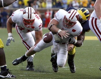 ANN ARBOR, MI - SEPTEMBER 27: Allan Evridge #4 of the Wisconsin Badgers fumbles the ball late in the forth quarter on a hit by Brandon Graham #55 of the Michigan Wolverines on September 27, 2008 at Michigan Stadium in Ann Arbor, Michigan. (Photo by Gregor