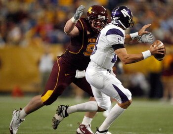 MINNEAPOLIS - NOVEMBER 01:  Eric Small #98 of the Minnesota Golden Gophers chases down Mike Kafka #13 of the Northwestern Wildcats for a sack during the second quarter at the Hubert H.Humphrey Metrodome on November 1, 2008 in Minneapolis, Minnesota  (Phot