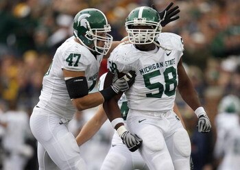 ANN ARBOR, MI - OCTOBER 25: Trevor Anderson #58 of the Michigan State Spartans is congratulated by Brandon Long #47 after a second quarter sack while playing the Michigan Wolverines on October 25, 2008 at Michigan Stadium in Ann Arbor, Michigan.  (Photo b