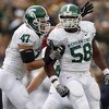 ANN ARBOR, MI - OCTOBER 25: Trevor Anderson #58 of the Michigan State Spartans is congratulated by Brandon Long #47 after a second quarter sack while playing the Michigan Wolverines on October 25, 2008 at Michigan Stadium in Ann Arbor, Michigan.  (Photo b