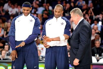 PHOENIX - FEBRUARY 15:  (L-R) LeBron James and Kobe Bryant, members of the gold medal winning USA Olympic basketball team, admire their rings as USA Basketball president Jerry Colangelo looks on during half time of the 58th NBA All-Star Game, part of 2009