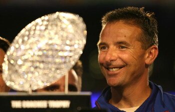 MIAMI - JANUARY 08:  Urban Meyer of the Florida Gators smiles as he is presented with the National Championship trophy after their 24-14 win against the Oklahoma Sooners during the FedEx BCS National Championship game at Dolphin Stadium on January 8, 2009