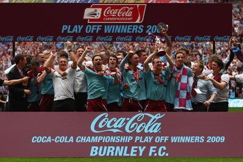 LONDON - MAY 25:  Burnley players celebrate victory with the trophy during the Coca-Cola Championship Playoff Final between Burnley and Sheffield United at Wembley Stadium on May 25, 2009 in London, England.  (Photo by Jamie McDonald/Getty Images)
