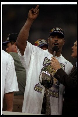 26 Jan 1997:  Defensive lineman Reggie White of the Green Bay Packers gets interviewed by FOX Sports commentator and Hall of Fame quarterback Terry Bradshaw after Super Bowl XXXI against the New England Patriots at the Superdome in New Orleans, Louisiana.