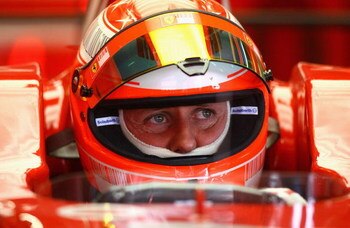 BARCELONA, SPAIN - FEBRUARY 25:  Michael Schumacher of Germany and Ferrari looks on from the pits during day one of the Formula One Testing at the Circuit de Catalunya on February 25, 2008 in Barcelona, Spain.  (Photo by Ryan Pierse/Getty Images)
