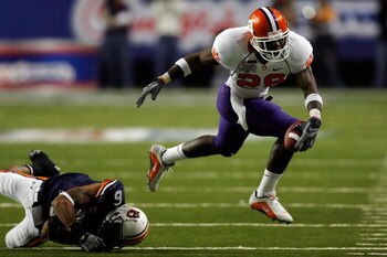 ATLANTA - DECEMBER 31:  C.J. Spiller #28 of the Clemson University Tigers is tripped by Walter McFadden #6 of the Auburn University Tigers during the Chick-Fil-A Bowl on December 31, 2007 at the Georgia Dome in Atlanta, Georgia. Auburn defeated Clemson 23