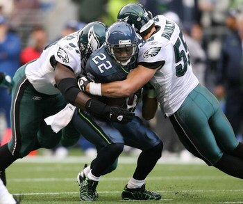 SEATTLE - NOVEMBER 02:  Running back Julius Jones #22 of the Seattle Seahawks is wrapped up by Brodrick Bunkley #97 and Stewart Bradley #55 of the Philadelphia Eagles on November 2, 2008 at Qwest Field in Seattle, Washington. The Eagles defeated the Seaha