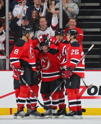 NEWARK, NJ - JANUARY 02: Brian Gionta #14 (C) of the New Jersey Devils is congratulated on his first period gaol against the Montreal Canadiens on January 2, 2009 at the Prudential Center in Newark, New Jersey. (Photo by Bruce Bennett/Getty Images)