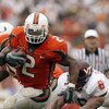 MIAMI - DECEMBER 7:  Running back Willis McGahee #2 of the University of Miami Hurricanes evades linebacker Vegas Robinson #6 of the Virginia Polytechnic Institute and State University Hokies during the game at the Orange Bowl on December 7, 2002 in Miami