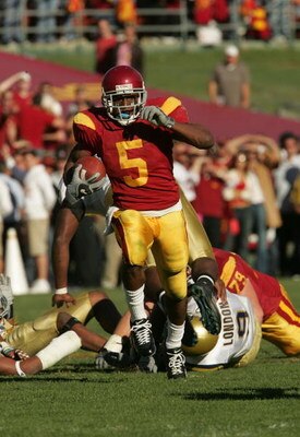 LOS ANGELES, CA - DECEMBER 03:  Reggie Bush #5 of the USC Trojans rushes the ball against the UCLA Bruins December 3, 2005 at the Los Angeles Memorial Coliseum in Los Angeles, California. USC won 66-19.  (Photo by Stephen Dunn/Getty Images)