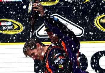 LONG POND, PA - AUGUST 03:  Denny Hamlin (L), driver of the #11 FedEx Express Toyota, celebrates with a crew member in victory lane after winning the NASCAR Sprint Cup Series Sunoco Red Cross Pennsylvania 500 at the Pocono Raceway on August 3, 2009 in Lon