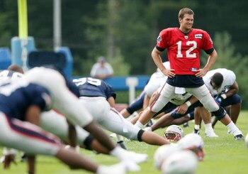 FOXBORO, MA - JULY 31:  Tom Brady #12 of the New England Patriots stretches during training camp on July 31, 2009 at Gillette Stadium in Foxboro, Massachusetts.  (Photo by Elsa/Getty Images)