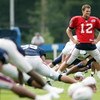 FOXBORO, MA - JULY 31:  Tom Brady #12 of the New England Patriots stretches during training camp on July 31, 2009 at Gillette Stadium in Foxboro, Massachusetts.  (Photo by Elsa/Getty Images)