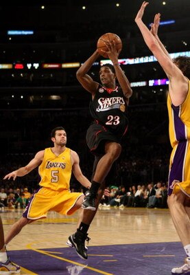 LOS ANGELES - MARCH 17:  Louis Williams #23 of the Philadelphia 76ers passes off as he drives into the lane between Jordan Farmar #5 and Pau Gasol #16 of the Los Angeles Lakers on March 17, 2009 at Staples Center in Los Angeles, California.  The 76ers won