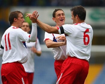 SHEFFIELD, ENGLAND - AUGUST 01:  Ryan Nelsen of Blackburn Rovers celebrates with Stephen Warnock (l) and Keith Andrews (c) after scoring the opening goal during a Pre Season Friendly match between Sheffield Wednesday and Blackburn Rovers at the Hillsborou