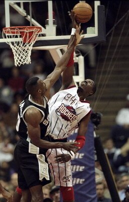 26 Jan 1999: Hakeem Olajuwon #34 of the Houston Rockets tips the ball during the game against the San Antonio Spurs at the Compaq Center in Houston, Texas. The Spurs defeated the Rockets 106-99.
