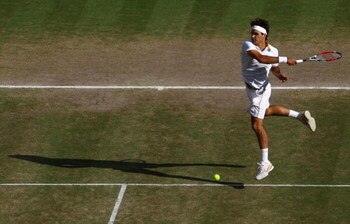 WIMBLEDON, ENGLAND - JULY 05:  Roger Federer of Switzerland plays a forehand during the men's singles final match against Andy Roddick of USA on Day Thirteen of the Wimbledon Lawn Tennis Championships at the All England Lawn Tennis and Croquet Club on Jul