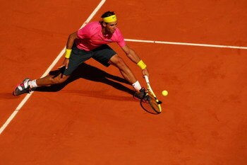 PARIS - MAY 29:  Rafael Nadal of Spain stretches for a backhand during his Men's Singles Third Round match against Lleyton Hewitt of Australia on day six of the French Open at Roland Garros on May 29, 2009 in Paris, France.  (Photo by Clive Brunskill/Gett