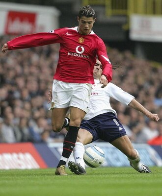 LONDON - SEPTEMBER 25:  Cristiano Renaldo of Manchester United is tackled by Pedro Mendes of Spurs during the Barclays Premiership match between Tottenham Hotspur and Manchester United on September 25, 2004 at White Hart Lane, London, England. (Photo by J