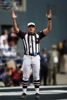 SEATTLE - SEPTEMBER 23:  Referee Ed Hochuli signals during the Seattle Seahawks game against the Cincinnati Bengals at Qwest Field on September 23, 2007 in Seattle, Washington. The Seahawks won 24-21. (Photo by Otto Greule Jr/Getty Images)