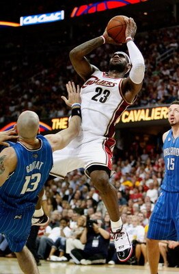 CLEVELAND - MAY 28: LeBron James #23 of the Cleveland Cavaliers shoots over Marcin Gortat #13 of the Orlando Magic in Game Five of the Eastern Conference Finals during the 2009 Playoffs at Quicken Loans Arena on May 28, 2009 in Cleveland, Ohio. NOTE TO US
