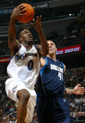WASHINGTON - NOVEMBER 5:  Gilbert Arenas #0 of the Washington Wizards goes to the basket in front of Dirk Nowitzki #41 of the Dallas Mavericks as Arenas had a game high 25 points and a triple double as the Wizards defeated the Mavericks 100-90 during NBA 