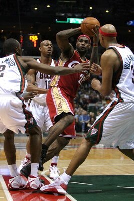 MILWAUKEE - FEBRUARY 20:  LeBron James #23 of the Cleveland Cavaliers looks to pass under pressure from (L-R) Luc Richard Mbah a Moute #12, Keith Bogans #10 and Charlie Villanueva #31 of the Milwaukee Bucks on February 20, 2009 at the Bradley Center in Mi