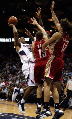 ATLANTA - MAY 09:  Joe Johnson #2 of the Atlanta Hawks shoots against Delonte West #13 and Anderson Varejao #17 of the Cleveland Cavaliers in Game Three of the Eastern Conference Semifinals during the 2009 NBA Playoffs at Philips Arena on May 9, 2009 in A