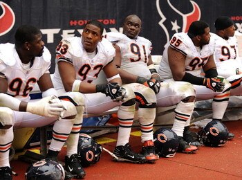 HOUSTON - DECEMBER 28:  Tommie Harris #91 and Adewale Ogunleye #93 of the Chicago Bears watch play from the bench in the final minutes of a 31-24 loss to the Houston Texans at the Reliant Stadium December 28, 2008 in Houston, Texas.  The Bears failed to m
