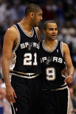 DALLAS - MARCH 23:  Forward Tim Duncan #21 and Tony Parker #9 of the San Antonio Spurs hug during play with the Dallas Mavericks on March 23, 2008 at American Airlines Center in Dallas, Texas.  NOTE TO USER: User expressly acknowledges and agrees that, by