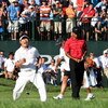 CHASKA, MN - AUGUST 16:  (L-R) Y.E. Yang of South Korea celebrates a birdie putt on the 18th green alongside Tiger Woods during the final round of the 91st PGA Championship at Hazeltine National Golf Club on August 16, 2009 in Chaska, Minnesota.  (Photo b