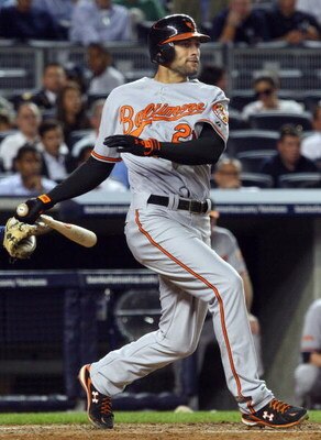 NEW YORK - JULY 20:  Nick Markakis #21 of the Baltimore Orioles bats against the New York Yankees on July 20, 2009 at Yankee Stadium in the Bronx borough of New York City.  (Photo by Jim McIsaac/Getty Images)