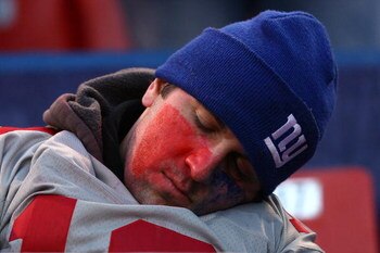 EAST RUTHERFORD, NJ - JANUARY 11:  A fan of the New York Giants sleeps during a game against the Philadelphia Eagles during the NFC Divisional Playoff Game on January 11, 2009 at Giants Stadium in East Rutherford, New Jersey.The Eagles won the game by a s