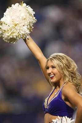 MINNEAPOLIS - DECEMBER 2:  A cheerleader of the Minnesota Vikings carries the ball during the NFL game against the Detroit Lions at the Metrodome on December 2, 2007 in Minneapolis, Minnesota. (Photo by Stephen Dunn/Getty Images)