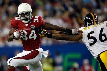 TAMPA, FL - FEBRUARY 01:  Running back Tim Hightower #34 of the Arizona Cardinals runs the ball and attempts to get bby linebacker LaMarr Woodley #56 of the Pittsburgh Steelers during Super Bowl XLIII on February 1, 2009 at Raymond James Stadium in Tampa,