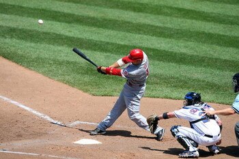 NEW YORK - JULY 12:  Joey Votto #19 of the Cincinnati Reds bats against the New York Mets on July 12, 2009 at Citi Field in the Flushing neighborhood of the Queens borough of New York City.  (Photo by Jim McIsaac/Getty Images)