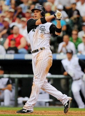 DENVER - AUGUST 13:  Clint Barmes #12 of the Colorado Rockies looks on as he hits a two-run home run in the seventh inning at Coors Field on August 13, 2009 in Denver, Colorado. (Photo by Doug Pensinger/Getty Images)