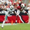 GLENDALE, AZ - SEPTEMBER 14:  Larry Fitzgerald #11 of the Arizona Cardinals completes a pass against Will Allen #25 of the Miami Dolphins at University of Phoenix Stadium on September 14, 2008 in Glendale, Arizona.  (Photo by Lisa Blumenfeld/Getty Images)
