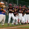 SOUTH WILLIAMSPORT, PA - AUGUST 23:  Members of the Northwest team from Oregon dance with the Little League mascot 'Dugout' before they play the Great Lakes team from Illinois during the United States Semifinal game in the Little League World Series on Au