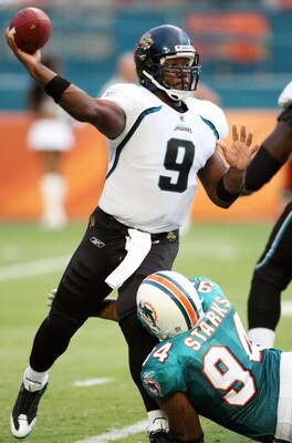MIAMI - AUGUST 17:  Quarterback David Garrard #9 of the Jacksonville Jaguars throws a pass as he is hit by defensive end Randy Starks #94 of the Miami Dolphins during a preseason game at Landshark Stadium on August 17, 2009 in Miami, Florida.  (Photo by D
