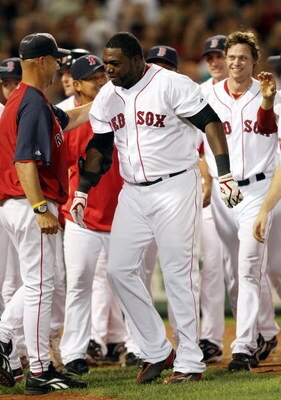 BOSTON - AUGUST 26:  David Ortiz #34 of the Boston Red Sox is congratulated by manager Terry Francona #47 after Ortiz hit a solo home run in the bottom of the 9th inning to win the game over the Chicago White Sox on August 26, 2009 at Fenway Park in Bosto