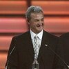 VANCOUVER, BC - JUNE 22:  Head coach Darryl Sutter of the Calgary Flames accepts the Vezina Trophy for his player Miikka Kiprusoff, not in attendance, at the NHL TV Awards Show at The Centre in Vancouver for Performing Arts on June 22, 2006 in Vancouver, 