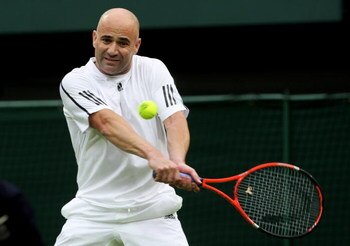 LONDON, ENGLAND - MAY 17:  Andre Agassi hits a backhand during the Mens Singles match against Tim Henman during the 'Centre Court Celebration' at Wimbledon on May 17, 2009 in London, England.  (Photo by Hamish Blair/Getty Images)