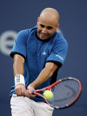 NEW YORK - SEPTEMBER 11:  Andre Agassi hits a backhand from Roger Federer of Switzerland during the men's final of the US Open at the USTA National Tennis Center in Flushing Meadows Corona Park on September 11, 2005 in the Flushing neighborhood of the Que
