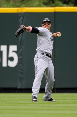 DENVER - MAY 10:  Center fielder Cody Ross #12 of the Florida Marlins fields a ball against the Colorado Rockies during MLB action at Coors Field on May 10, 2009 in Denver, Colorado. The Rockies defeated the Marlins 3-2.  (Photo by Doug Pensinger/Getty Im