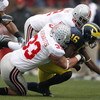 ANN ARBOR, MI - NOVEMBER 17: Adrian Arrington #16 of the Michigan Wolverines is tackled by James Laurinaitis #33 and Malcolm Jenkins #2 of the Ohio State Buckeyes on November 17, 2007 at Michigan Stadium in Ann Arbor, Michigan. Ohio State won the game 14-