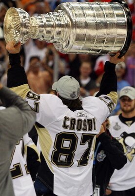 DETROIT - JUNE 12:  Sidney Crosby #87 of the Pittsburgh Penguins celebrates with the Stanley Cup after defeating the Detroit Red Wings by a score of 2-1 to win Game Seven and the 2009 NHL Stanley Cup Finals at Joe Louis Arena on June 12, 2009 in Detroit, 