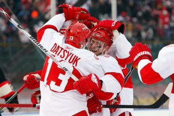 CHICAGO - JANUARY 01:  (L-R) Pavel Datsyuk #13 and Brian Rafalski #28 of the Detroit Red Wings celebrate after Datsyuk scored a goal in the second period against the Chicago Blackhawks during the NHL Winter Classic at Wrigley Field on January 1, 2009 in C